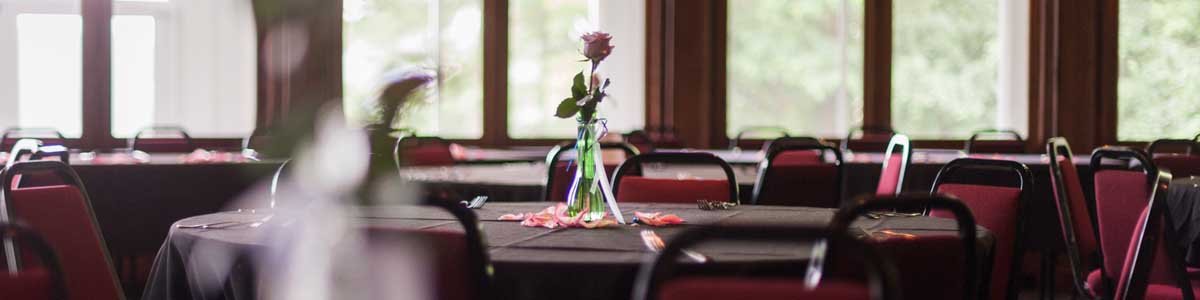 A picture showing linened tables set in a beautifully molded ballroom overlooking the Fox River in Appleton, WI